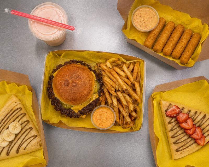 Cluck & Patty burger, fries, cheese sticks, crepes, and shake